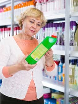 woman looking at household cleaning product